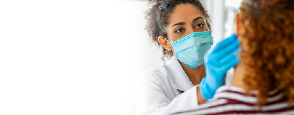 Dentist wearing a mask and working with a patient.